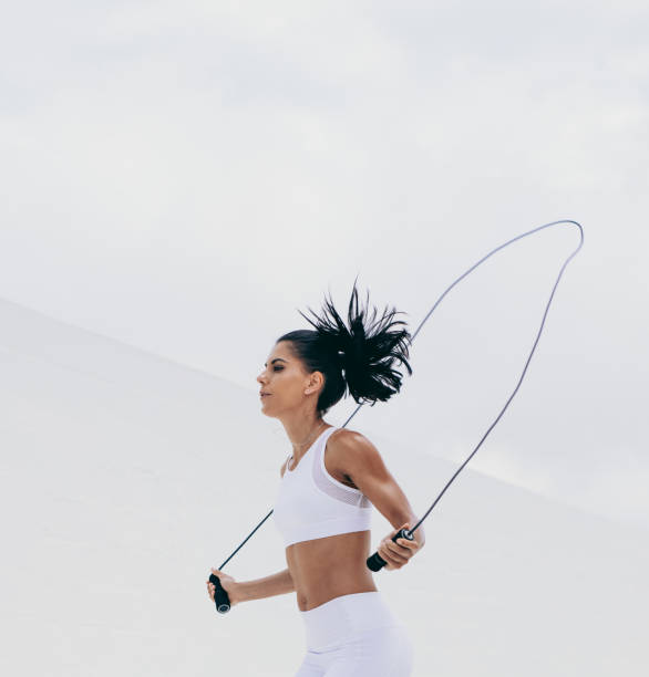 istock Fitness woman doing workout using a skipping rope 1134447778