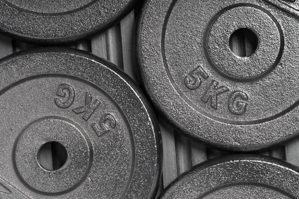istock Weight plates inside a weight training gym / fitness studio 1134449526