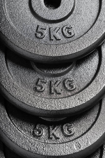 istock Barbell / dumbbell weight plates inside a weightlifting gym 1134449529