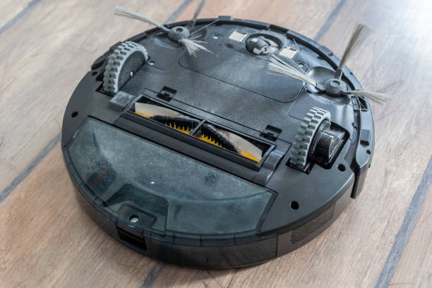 istock Bottom of a robot vacuum cleaner - wheels and brushes 1134449698