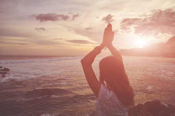 istock Young woman practicing yoga - meditation on the beach. 1134451093