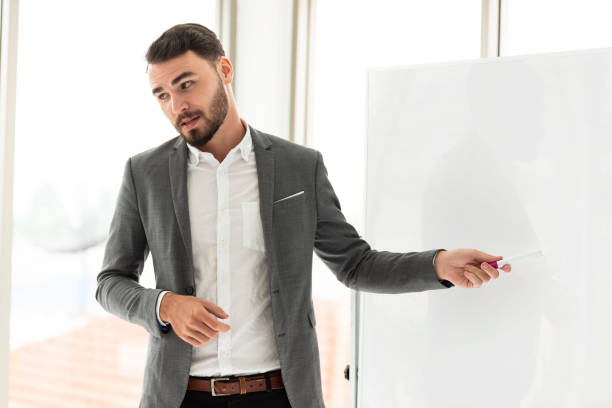 istock Young asian  businessman present Board project to interested diverse colleagues at office negotiations. 1134451175