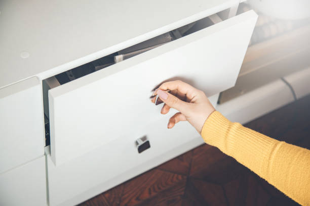 istock woman hand Open Kitchen Cabinet 1134453175
