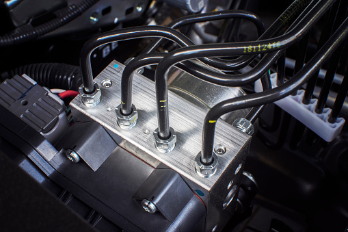 ABS unit module control box with pipes of car brake system.