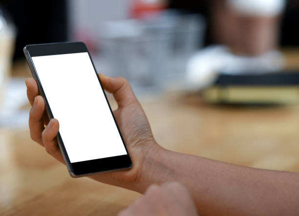 istock Female hand holding a smartphone blank screen,close-up shoot. 1134454754
