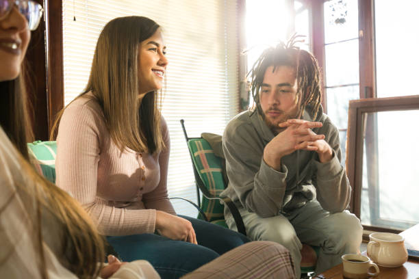 Cheerful friends laughing and communicating in a cafe