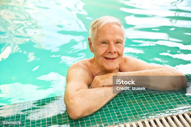 Smiling Retired Senior Man Leaning At Poolside Stock Photo - Download Image Now - Assisted Living, Lifestyles, Nursing Home