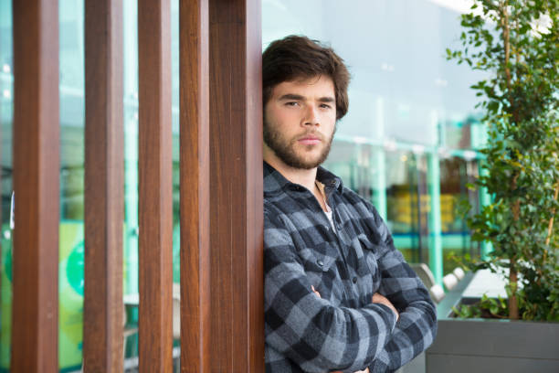 istock Serious attractive man standing outdoors with his arms crossed 1134456796