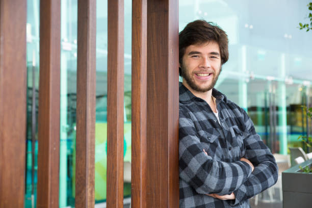 istock Smiling attractive man standing outdoors with his arms crossed 1134456830