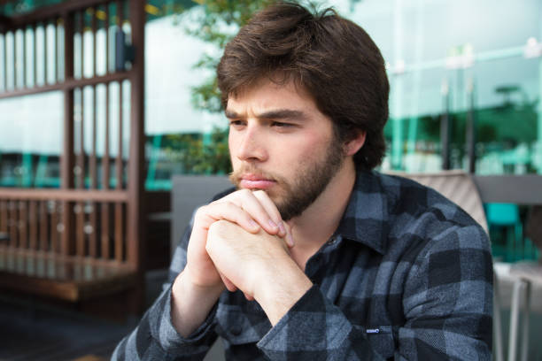 istock Upset young man thinking over bad news 1134456931