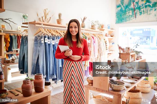 Portrait Of Female Owner Of Independent Clothing And Gift Store With Digital Tablet Stock Photo - Download Image Now
