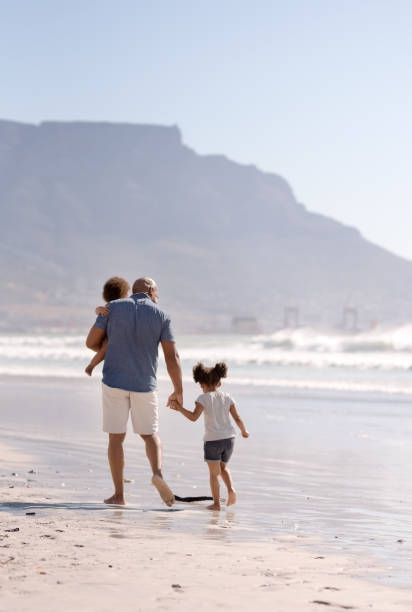 istock Family strolling on the beach 1134458535