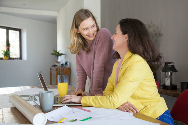 istock Positive lady designers discussing ideas in office 1134459616