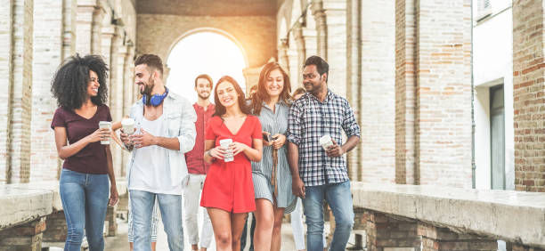istock Happy millennials friends having fun together - Young students drinking coffee and laughing together in old town street- Youth lifestyle, school and friendship concept - Main focus on center girl face 1134460049