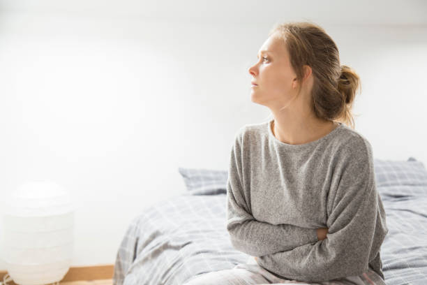 istock Sad stressed girl suffering from stomach pain 1134461580
