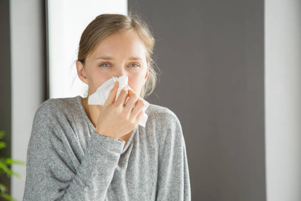 istock Pensive unhappy girl suffering from running nose 1134461593