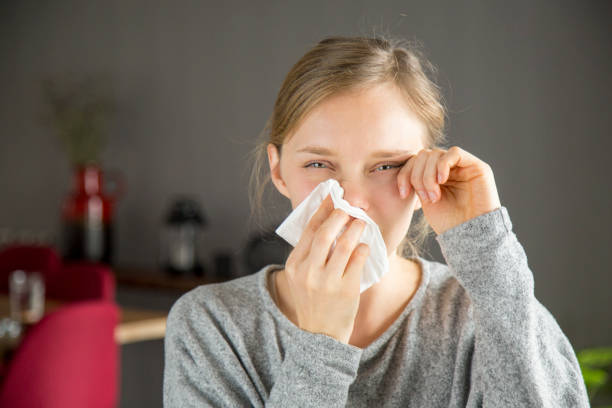 Stressed girl suffering from allergy stock photo