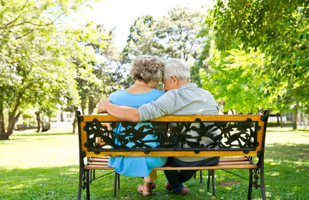 istock Senior couple sitting at bench in back yard 1134462267