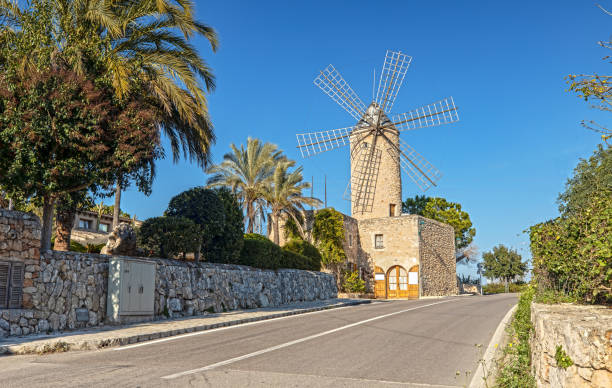 Don Quijote and Sancho Panza at the windmills in sunset