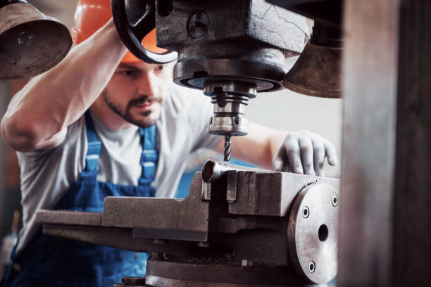 istock Experienced operator in a hard hat. Metalworking industry concept professional engineer metalworker operating CNC milling machine center in manufacturing workshop 1134465732