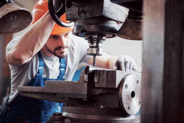 istock Experienced operator in a hard hat. Metalworking industry concept professional engineer metalworker operating CNC milling machine center in manufacturing workshop 1134465880