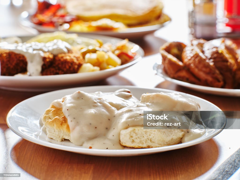 biscuits and gravy with breakfast foods on plate biscuits and gravy with breakfast foods on plate shot with selective focus Gravy Stock Photo