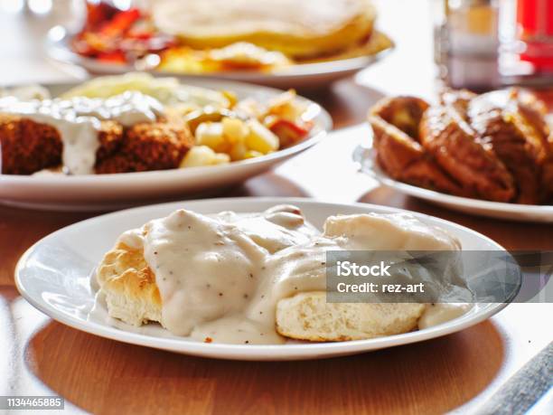 Biscuits And Gravy With Breakfast Foods On Plate Stock Photo - Download Image Now - Gravy, Biscuit - Quick Bread, Sausage