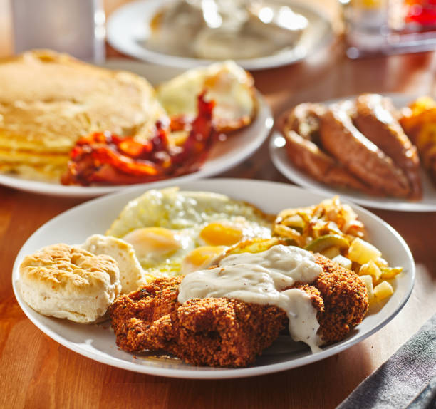 country fried steak with sunny side up eggs country fried steak with sunny side up eggs and biscuits steak and eggs breakfast stock pictures, royalty-free photos & images