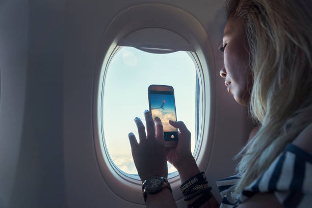 istock Taking photo by mobile phone in Airplane 1134467188
