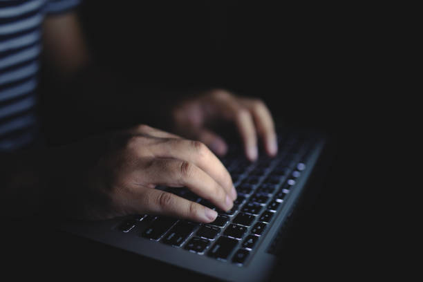istock Young man working on his laptop in the dark room. 1134468409