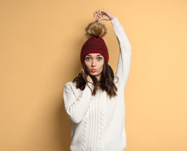 istock Funny woman touching pompom on hat 1134468850
