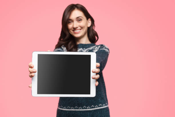 istock Glad female showing tablet with black screen 1134468871