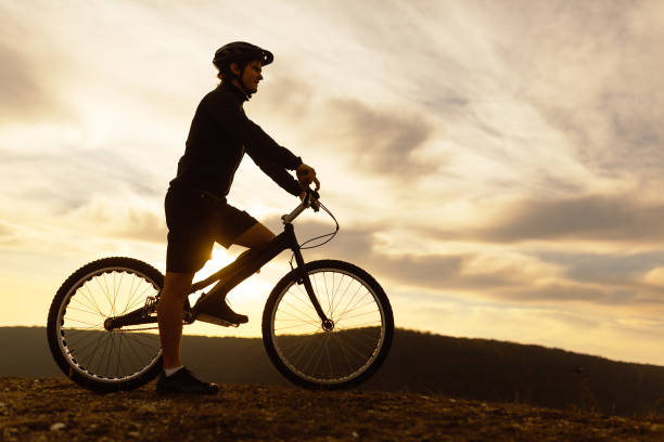 istock Man on bicycle against cloudy sky 1134468898