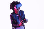 Cheerful black teenager playing VR game