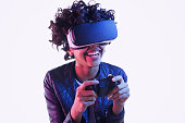 Laughing black teenager playing VR game