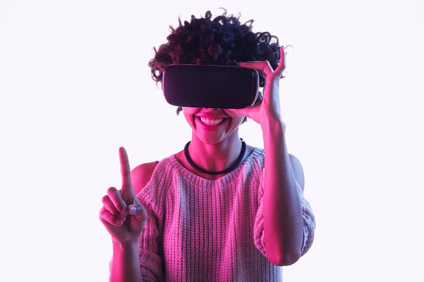 istock Black teenager in VR headset pointing up 1134468925
