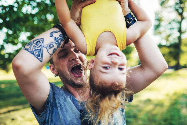 istock Millennial father and three year old son in park 1134468991