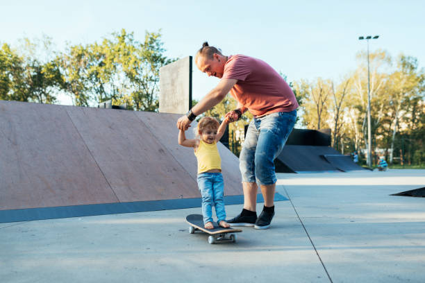 istock Modern dad with three year old son in skate park 1134469033