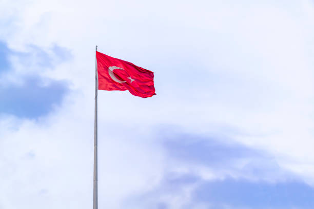 istock A huge Turkish flag waving in blue sky. 1134469689