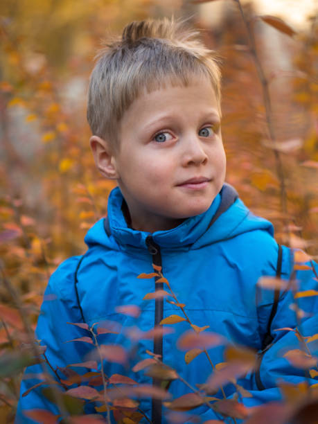 istock Surprised and pleased boy in autumn Park 1134470165