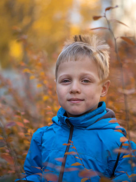 istock Lonely boy with a smile in autumn Park 1134470179