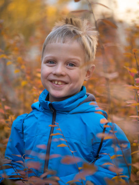 istock Lonely boy with a smile in autumn Park 1134470208