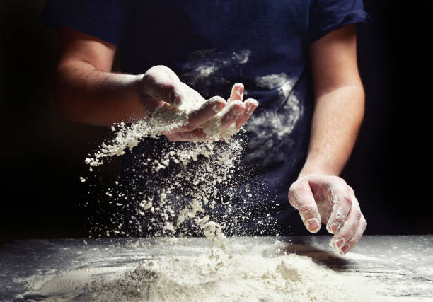 istock Baker with flour sifts through 1134470393