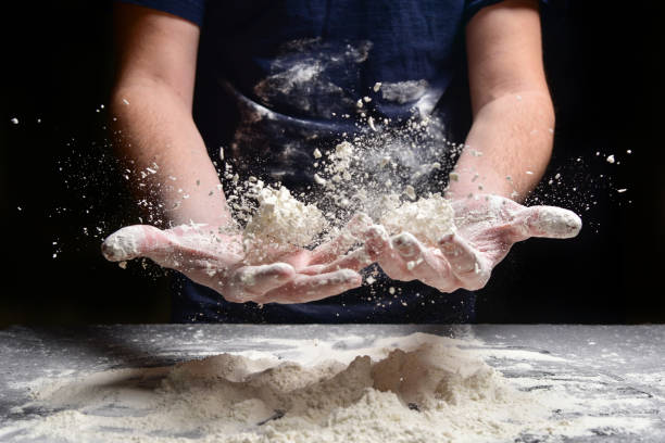 istock Male hands prepare bread, pie, pizza from flour. 1134470511
