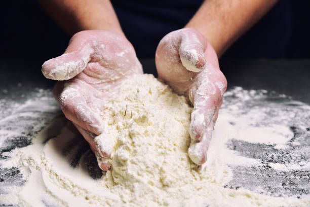 istock Male hands in flour, cooking pizza, pie, bread. 1134470515