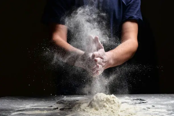 Photo of Hand clap of chef with splash flour