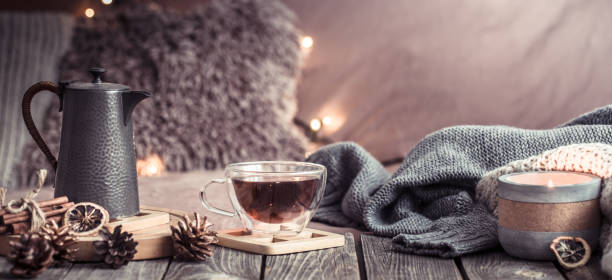 home comfort, details of the festive interior on a wooden table - poinsettia christmas candle table imagens e fotografias de stock