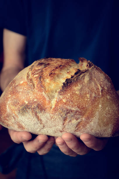istock Baked bread of sourdough in hands 1134475818