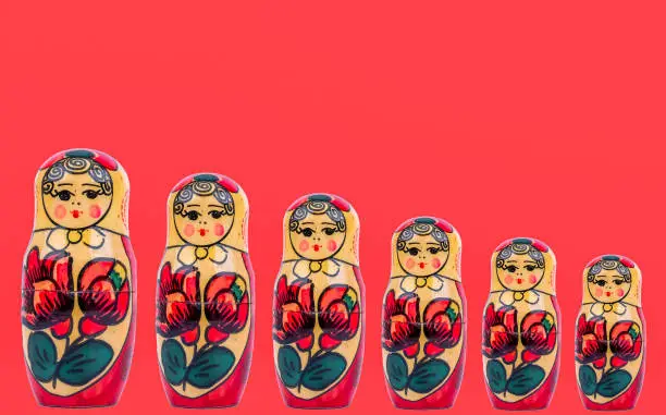 wooden figures of Russian babushka on a red background