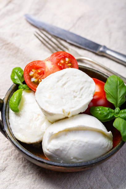 istock Soft white Italian cheese Mozzarella buffalo served with fresh tomato and green basil leaves 1134477113